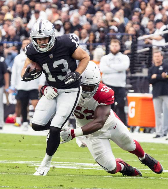 Las Vegas Raiders wide receiver Hunter Renfrow (13) tries to get away from Arizona Cardinals li ...