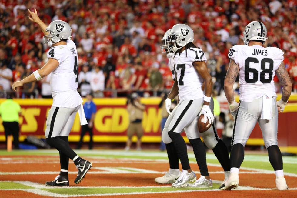 Raiders quarterback Derek Carr (4) calls for a two-point conversation play after a touchdown by ...