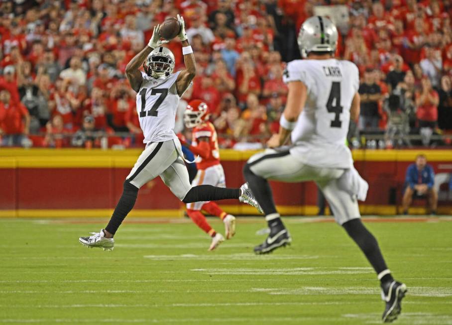 Las Vegas Raiders wide receiver Davante Adams (17) catches a pass from quarterback Derek Carr ( ...