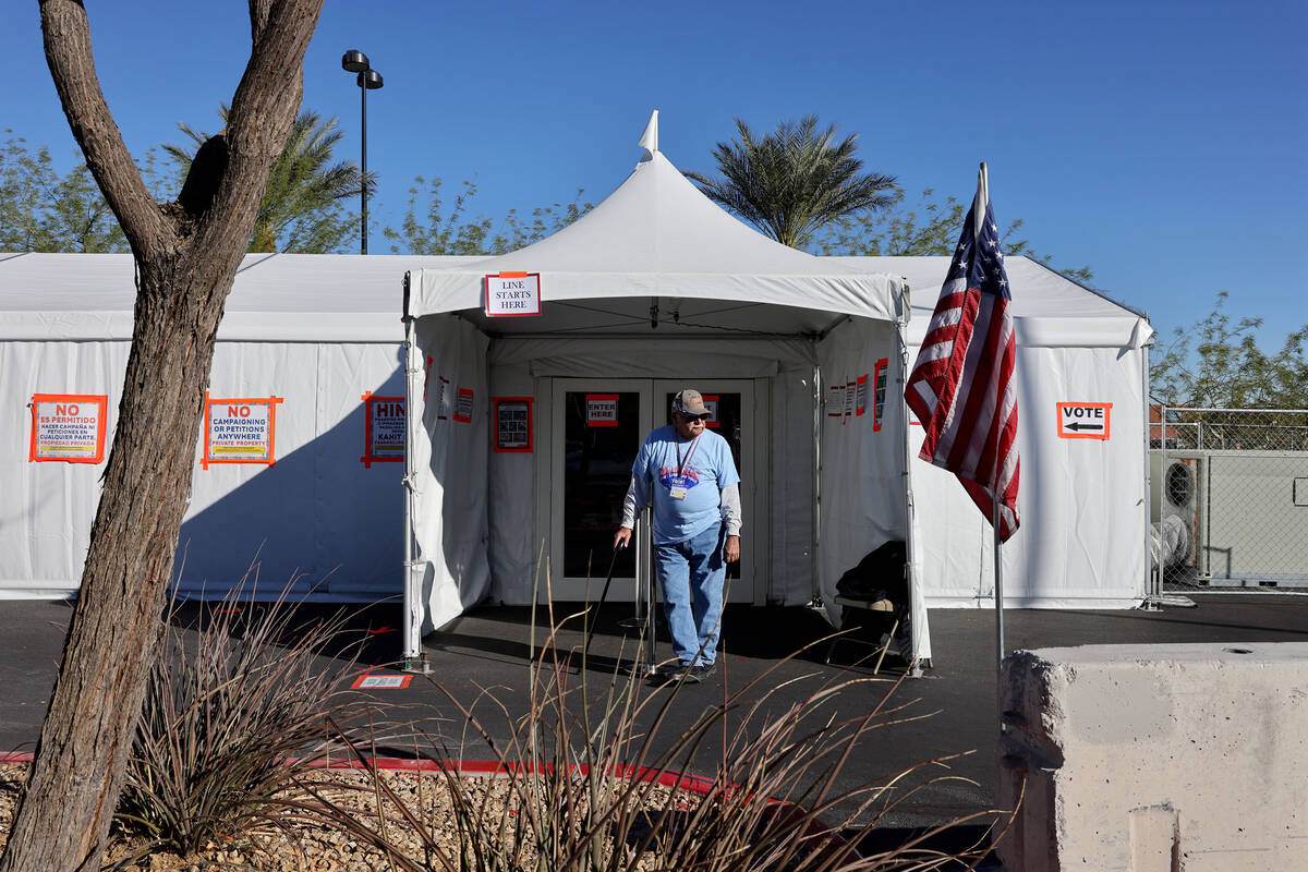Line monitor Frank Kostelac waits to help voters outside an event tent at Arroyo Market Square ...