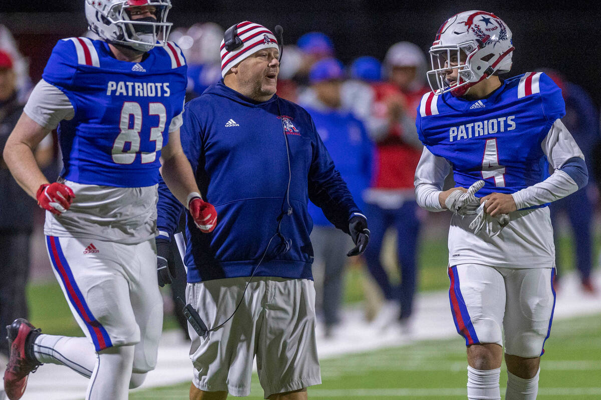 Liberty Head Coach Richard Muraco, center, calls a play with WR Colin Gregorio (4) versus Arbor ...