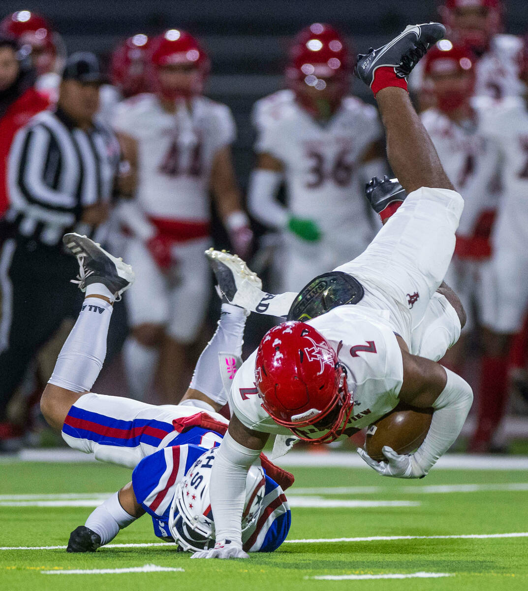 Arbor View RB Richard Washington (2) is tackled by Liberty CB Ezekiel Lopez (40) during the fir ...