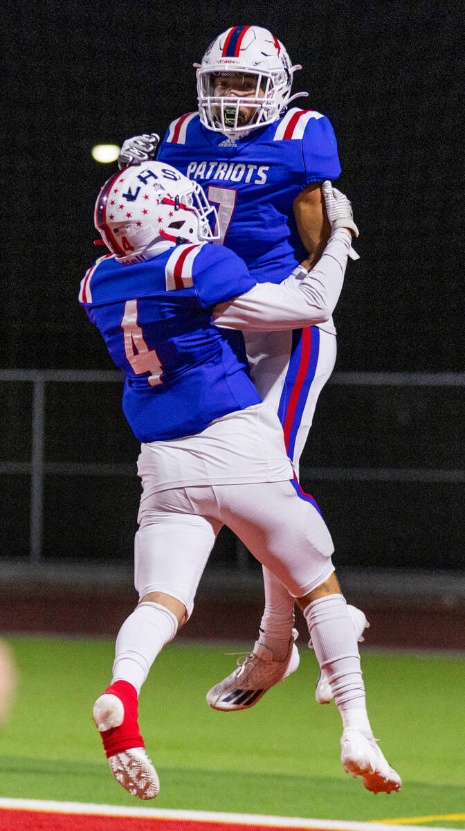 Liberty WR Jayden Robertson (7) celebrates a score with teammate WR Colin Gregorio (4) over Arb ...