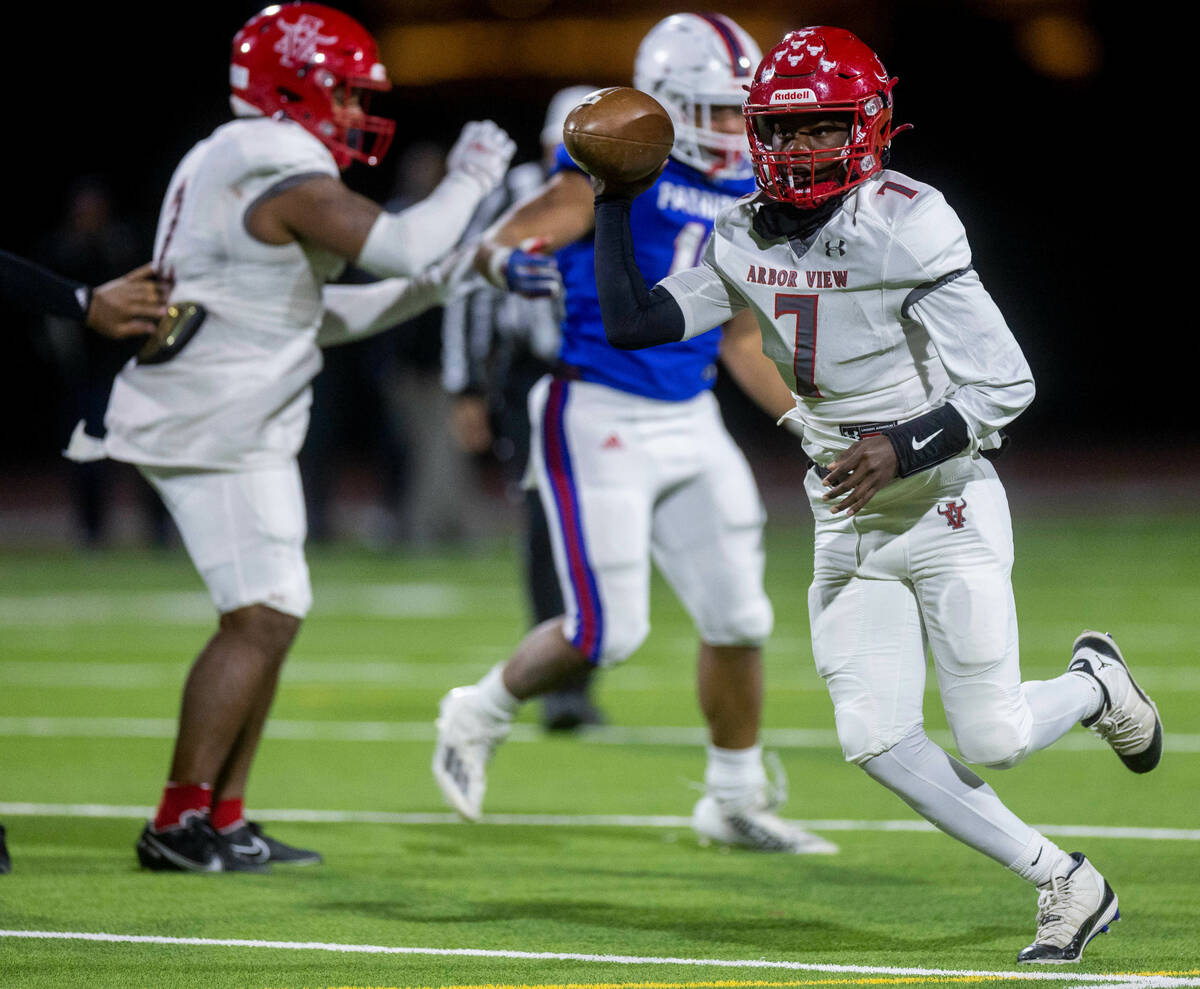 Arbor View QB Michael Kearns (7) scrambles while looking for a late pass over Liberty during th ...