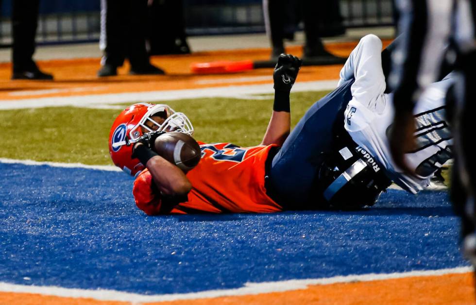 Bishop Gorman’s Micah Kaapana (22) scores a touchdown against Desert Pines during the fi ...