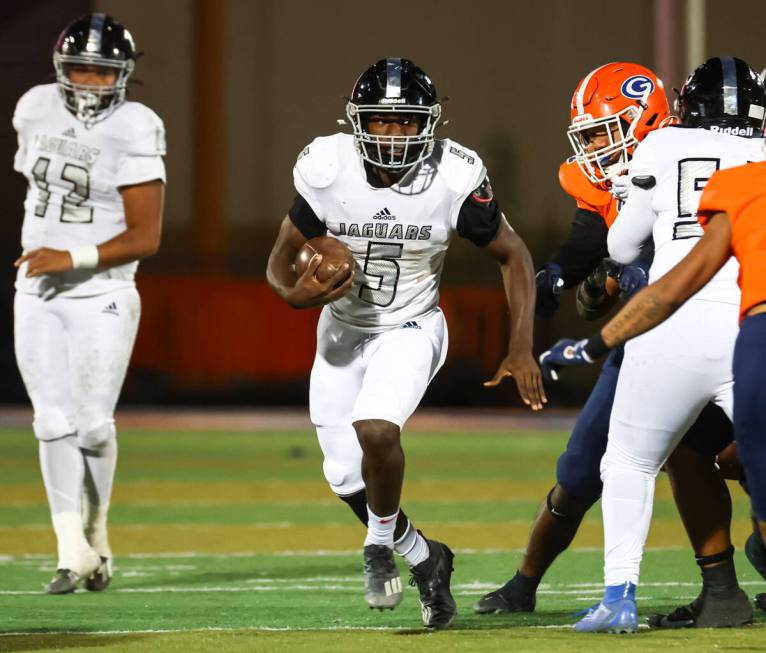 Desert Pines Greg Burrell (5) runs the ball during the first half of the Class 5A playoff footb ...