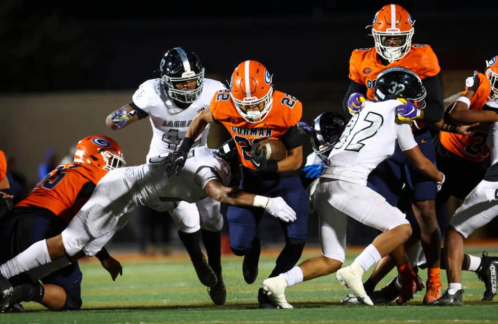 Bishop Gorman’s Micah Kaapana (22) runs the ball against Desert Pines during the first half o ...