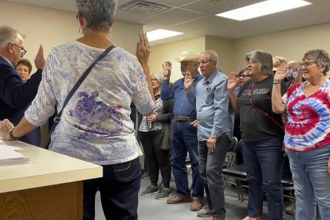 FILE - In this image from video, Nye County Clerk Mark Kampf, far left, in suit, swears in a gr ...