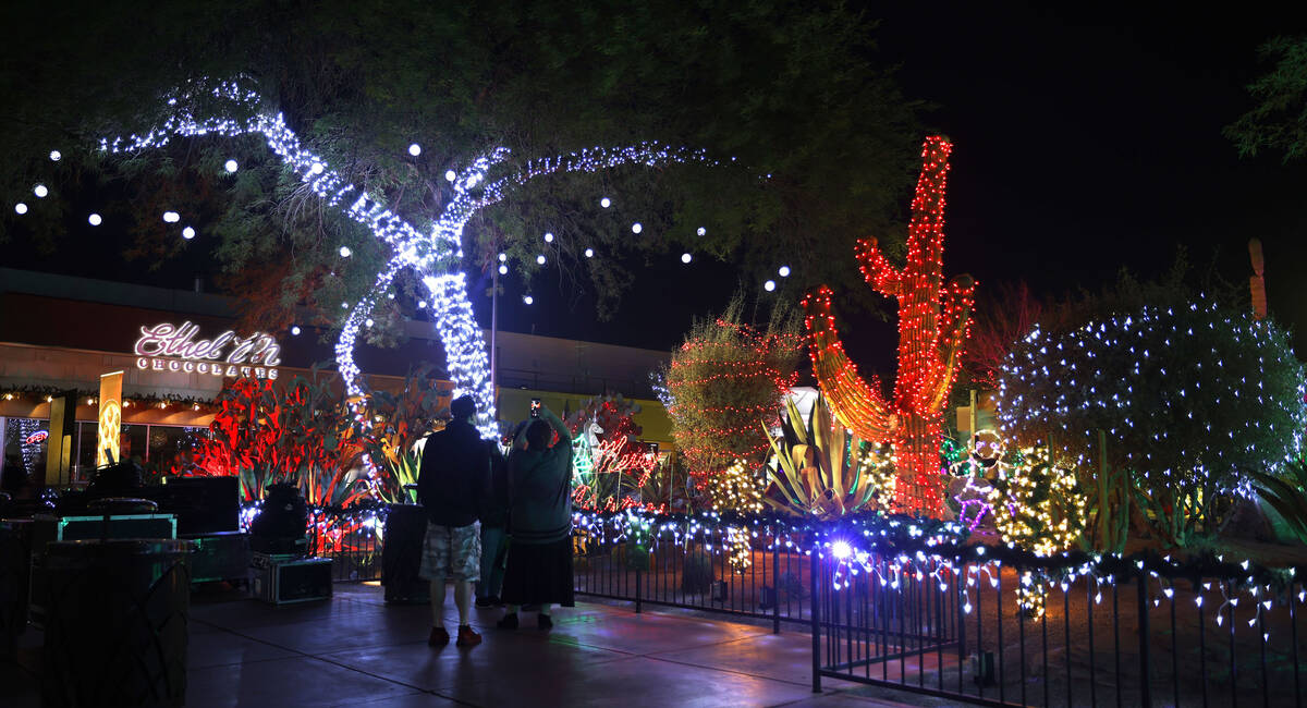 People watch holiday lights at the Ethel M Chocolates’ Cactus Garden in Henderson Friday ...