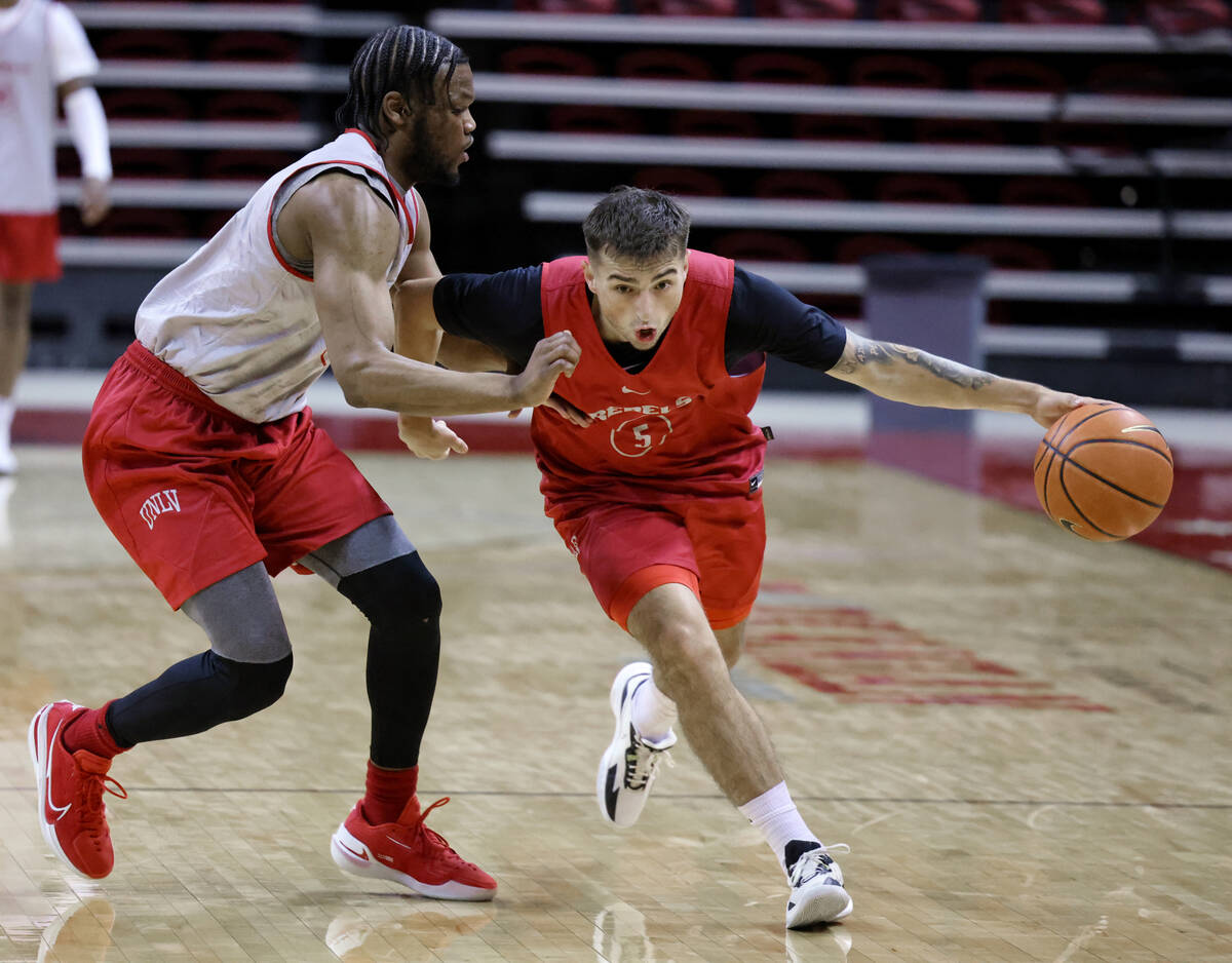 Jordan McCabe, 5, moves the ball up the court past EJ Harkless during practice at Thomas & ...