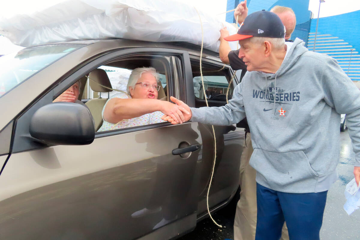 Jim "Mattress Mack" McIngvale, of Houston, shakes hands with a woman he had just given a free m ...