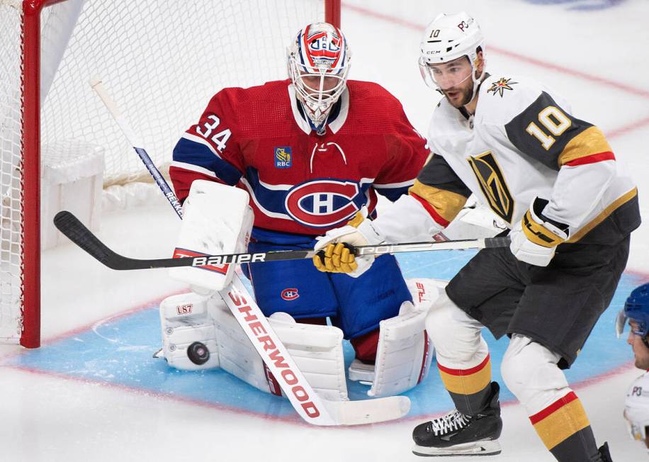 Vegas Golden Knights' Nicolas Roy and Montreal Canadiens goaltender Jake Allen watch the puck d ...