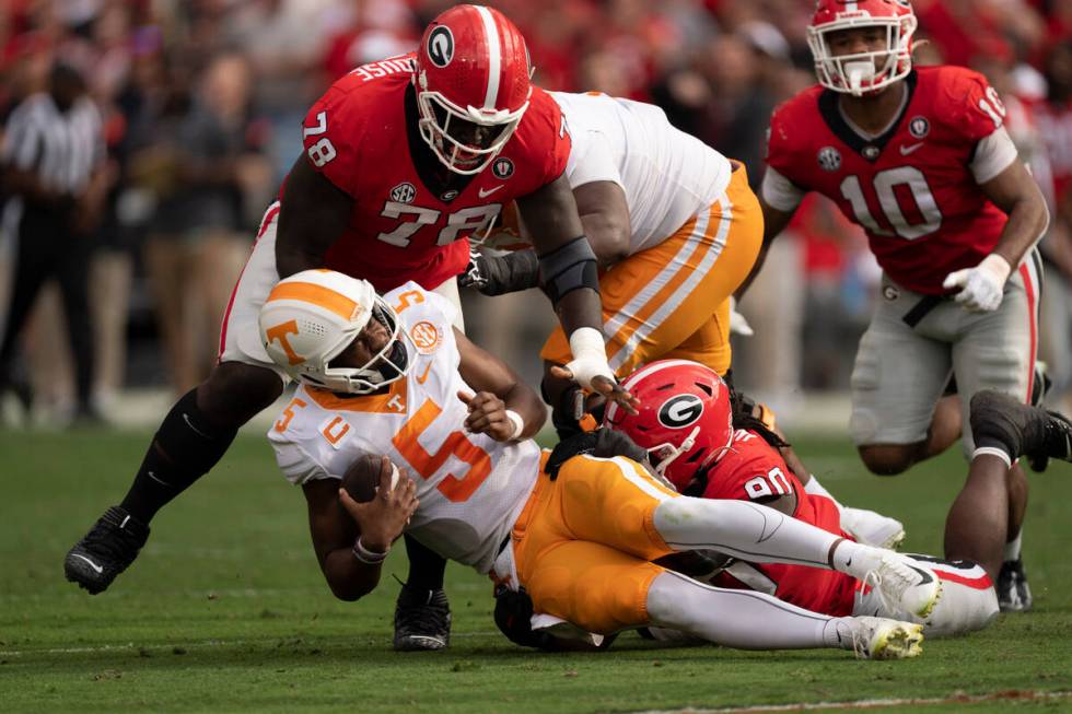 Tennessee quarterback Hendon Hooker (5) is sacked by Georgia defensive linemen Tramel Walthour ...