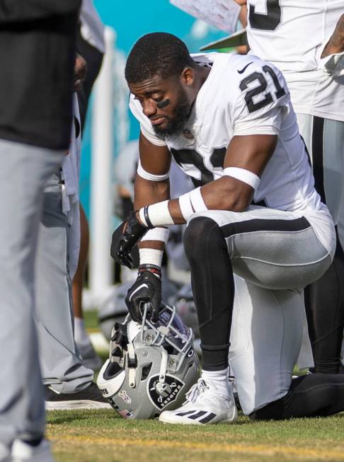 Raiders cornerback Amik Robertson (21) kneels down on the sideline during the second half of an ...