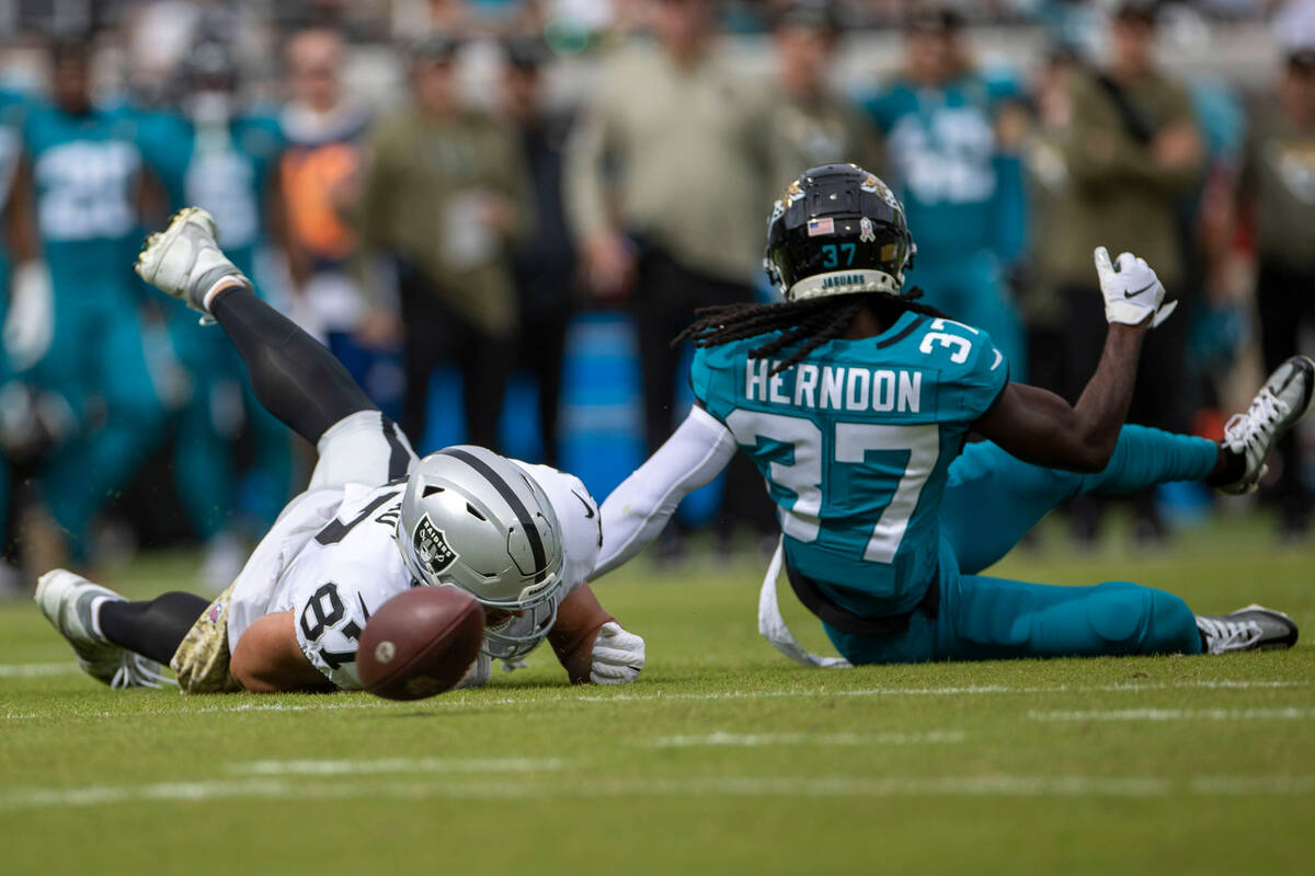 Raiders tight end Foster Moreau (87) can’t reel in a catch that is defended by Jacksonville J ...