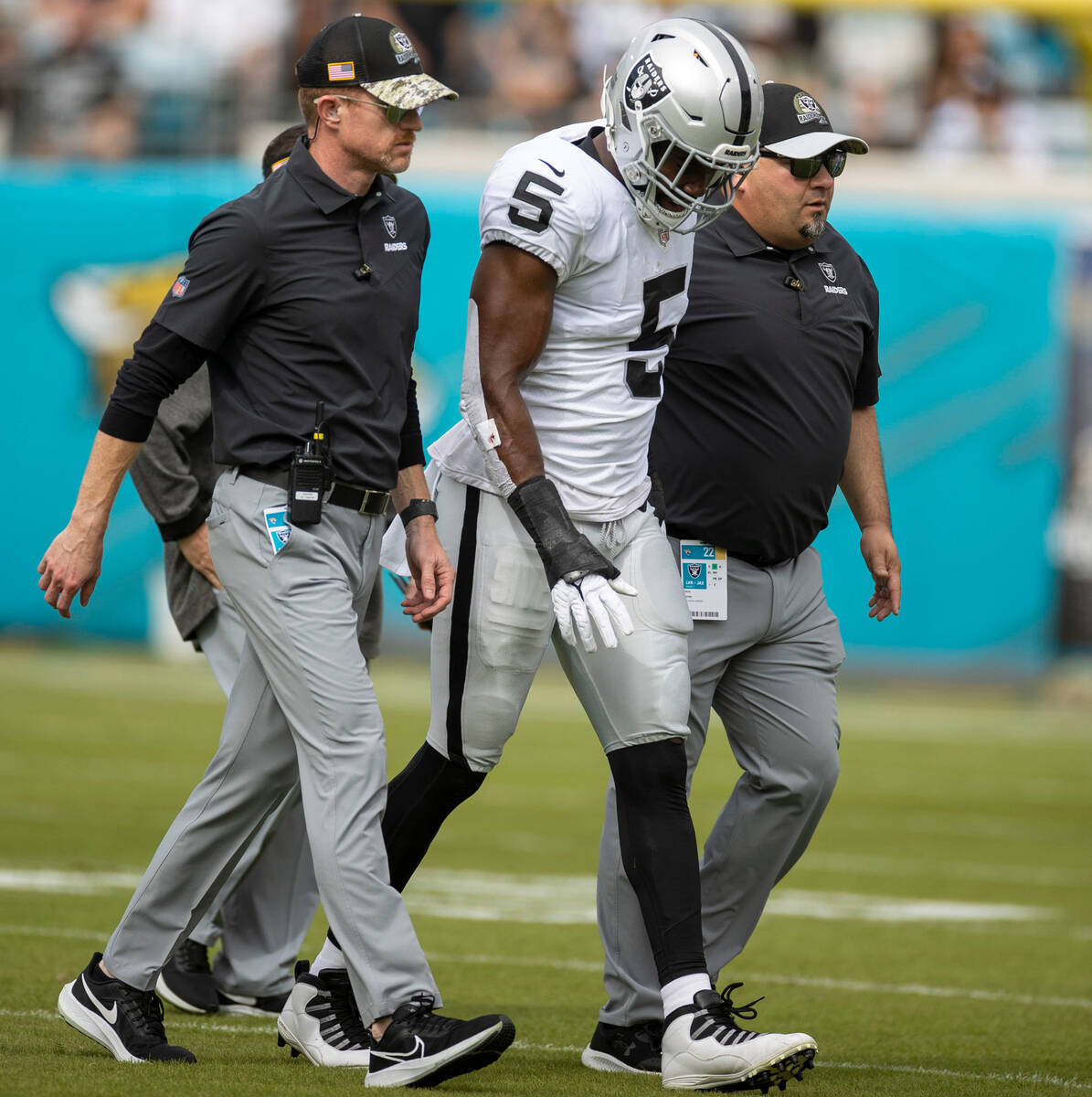 Raiders linebacker Divine Deablo (5) leaves the game with trainers during the first half of an ...