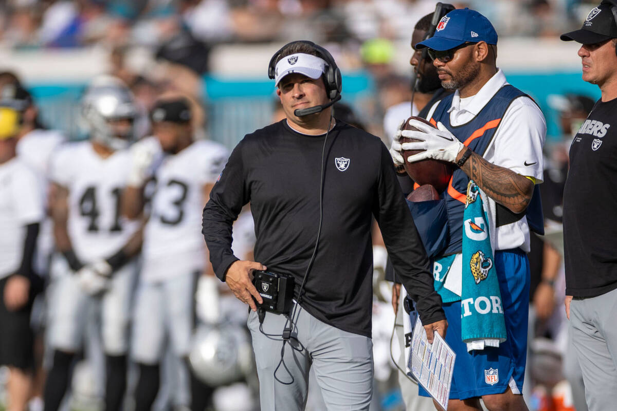 Raiders head coach Josh McDaniels looks to the scoreboard during the second half of an NFL game ...