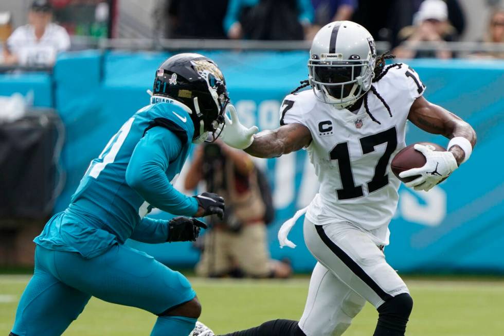 Las Vegas Raiders wide receiver Davante Adams (17) tries to get past Jacksonville Jaguars corne ...