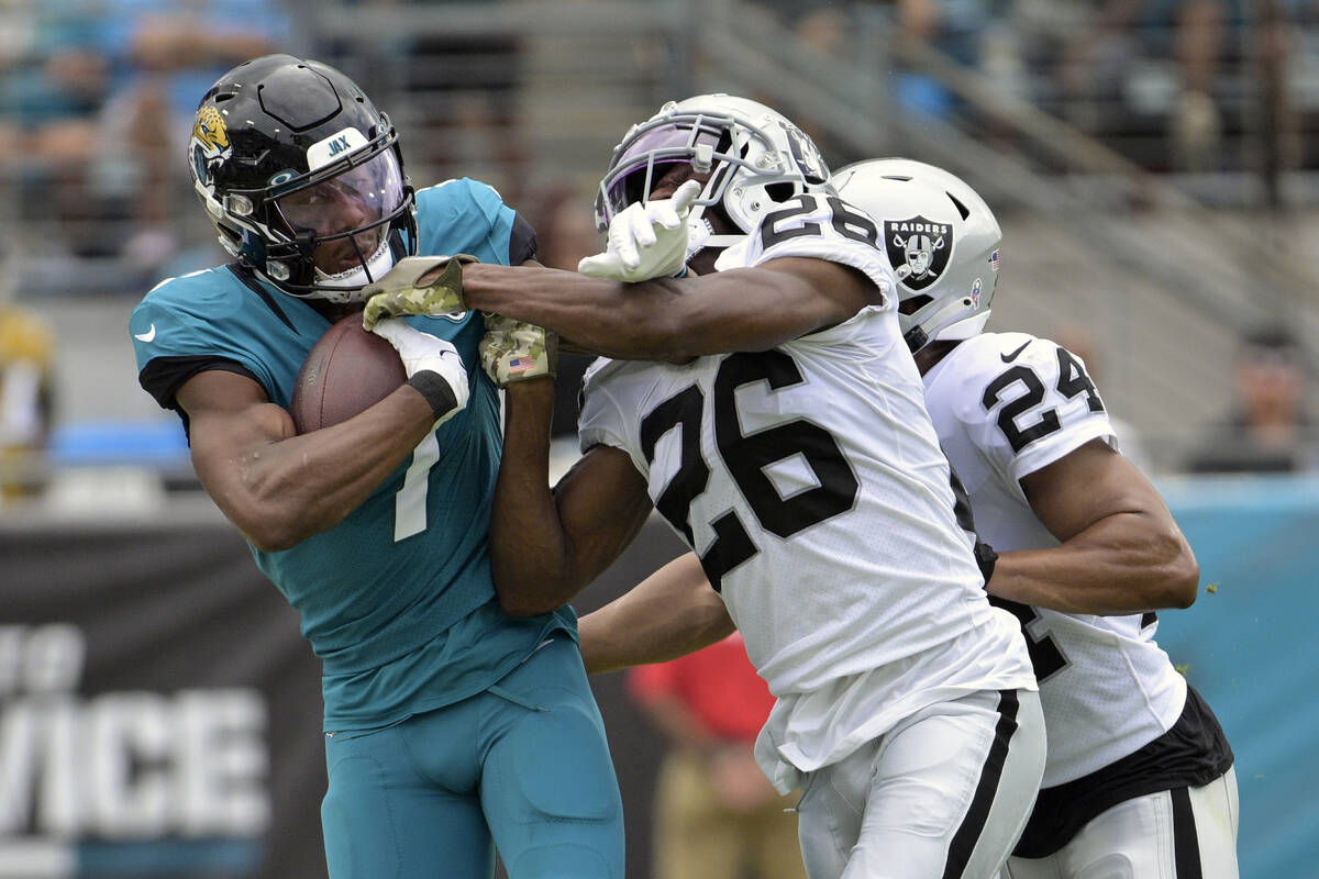 Jacksonville Jaguars wide receiver Zay Jones (7) is stopped by Las Vegas Raiders cornerback Roc ...