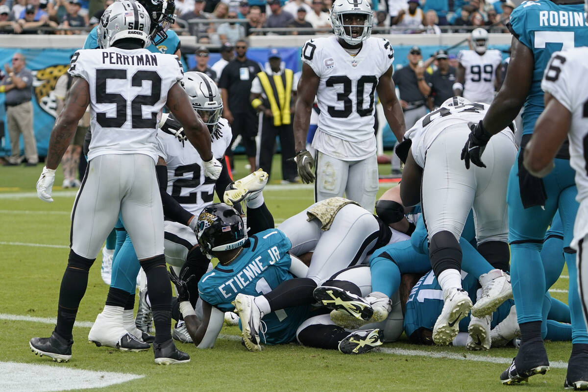 Jacksonville Jaguars running back Travis Etienne Jr. (1) scores a touchdown against the Las Veg ...