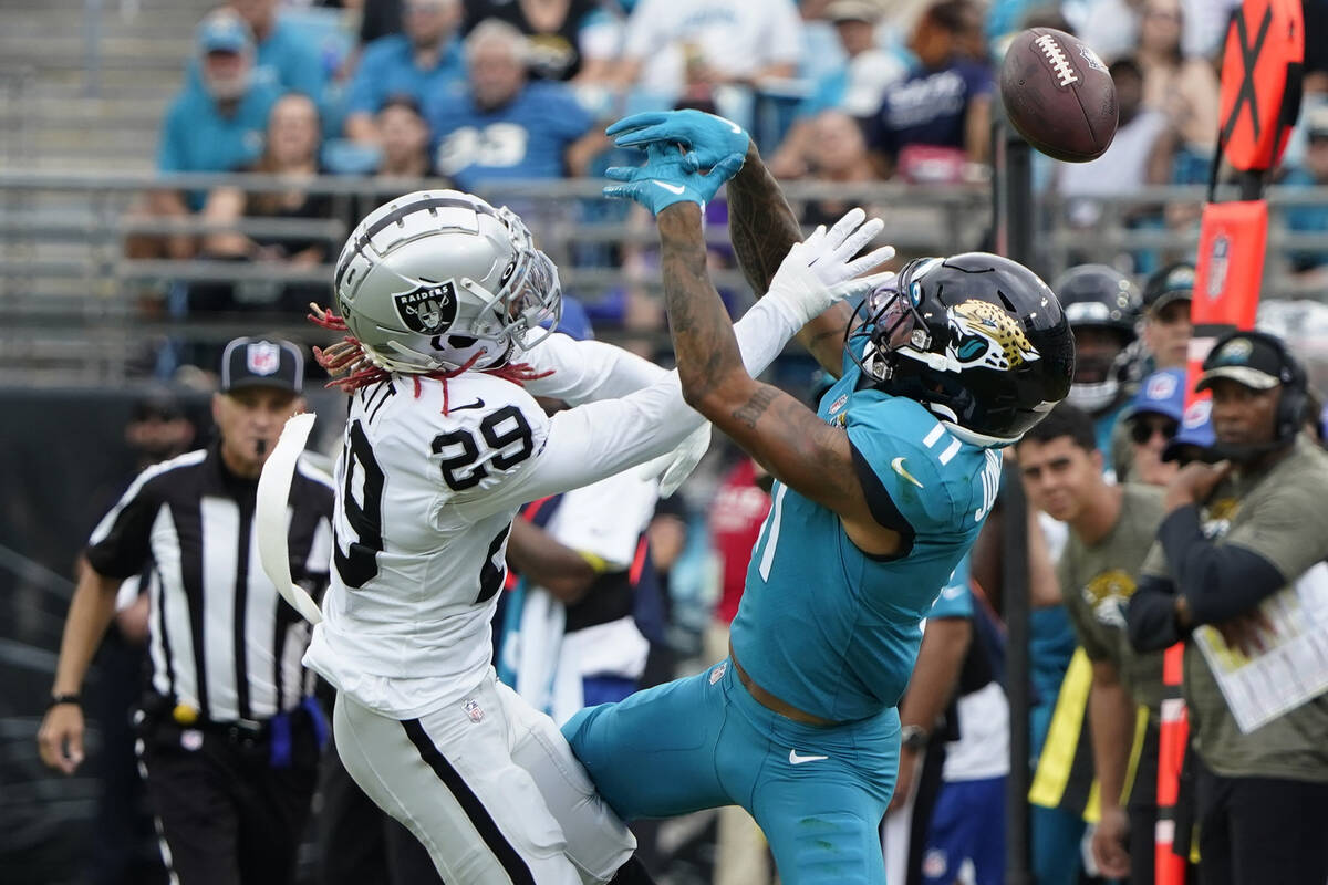 Las Vegas Raiders cornerback Anthony Averett (29) breaks up a pass intended for Jacksonville Ja ...