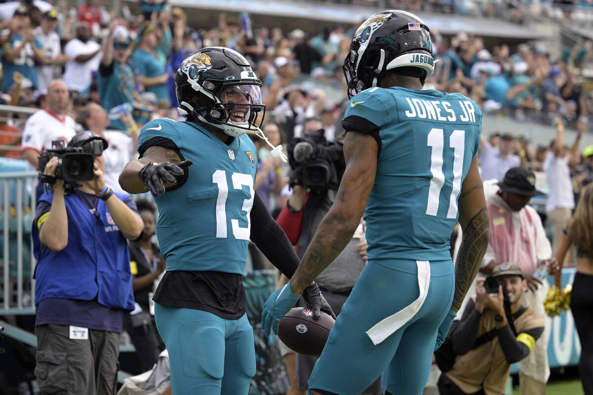 Jacksonville Jaguars wide receiver Christian Kirk (13) celebrates with Marvin Jones Jr. (11) af ...