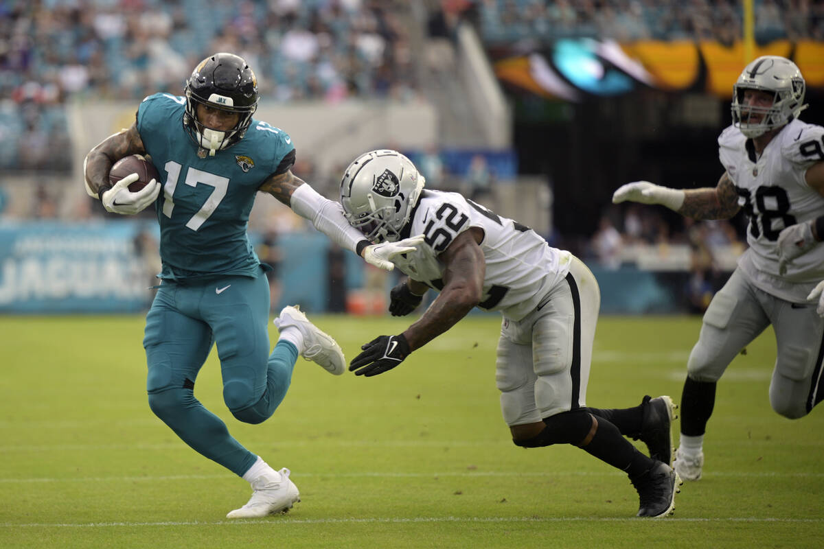 Jacksonville Jaguars tight end Evan Engram (17) tries to get past Las Vegas Raiders linebacker ...