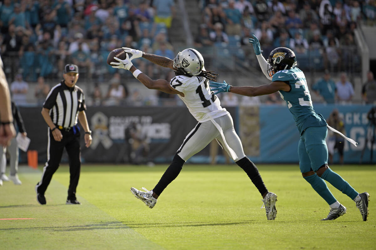 Las Vegas Raiders wide receiver Davante Adams (17) caches a pass in front of Jacksonville Jagua ...