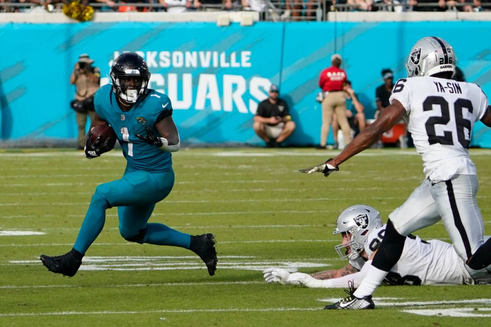 Jacksonville Jaguars running back Travis Etienne Jr. (1) gets past Las Vegas Raiders defensive ...