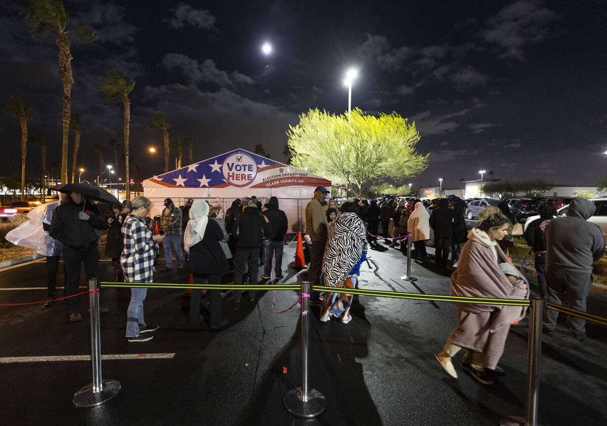 People wait in line to cast their vote at the Centennial Center polling center in Las Vegas, Tu ...