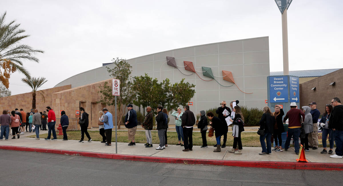 Voters bundle up while waiting in line on Election Day at Desert Breeze Community Center in Las ...