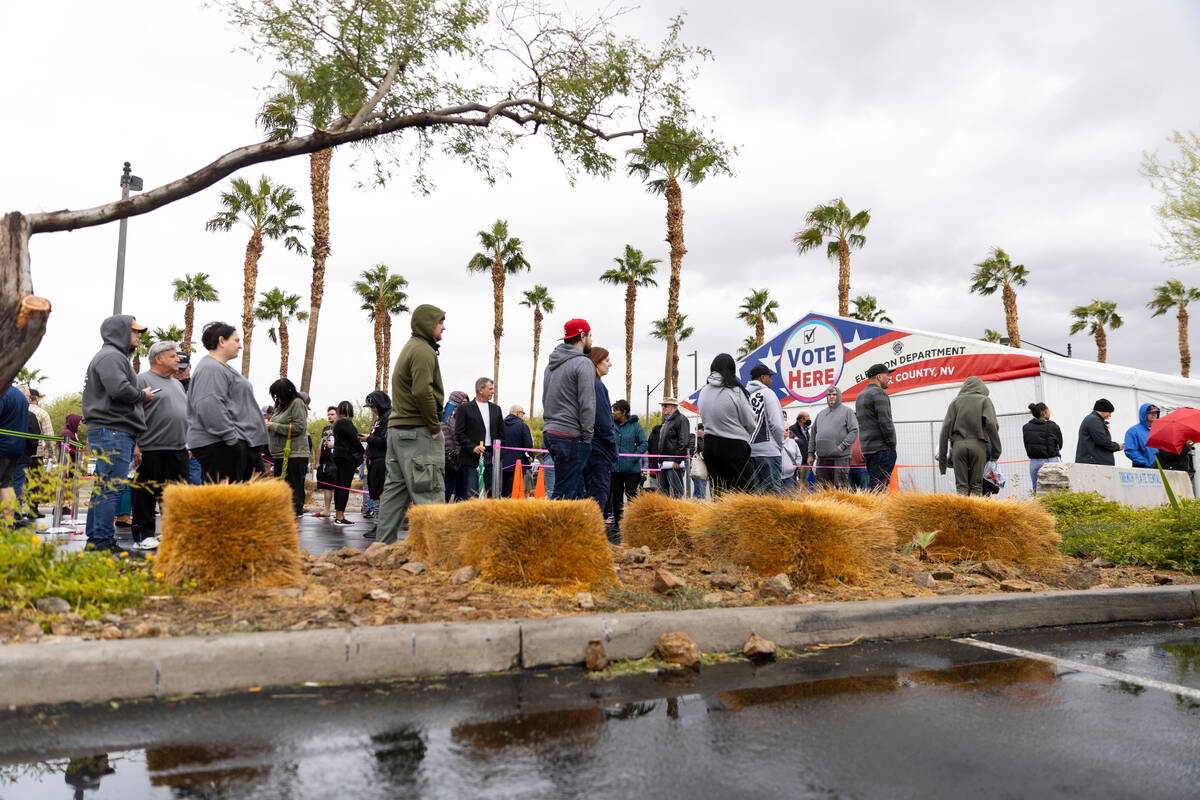 People wait in line to cast their vote at the Centennial Center polling place in Las Vegas, Tue ...