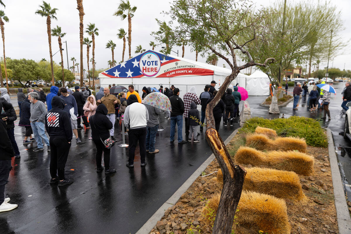 People wait in line to cast their vote at the Centennial Center polling place in Las Vegas, Tue ...