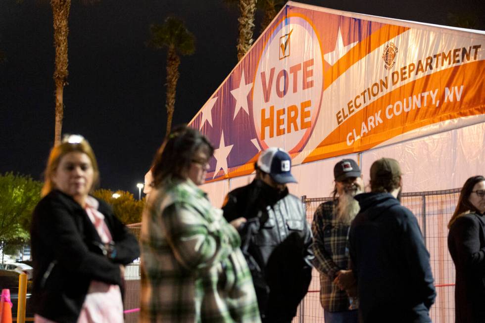 People wait in line to cast their vote at the Centennial Center polling center in Las Vegas, Tu ...