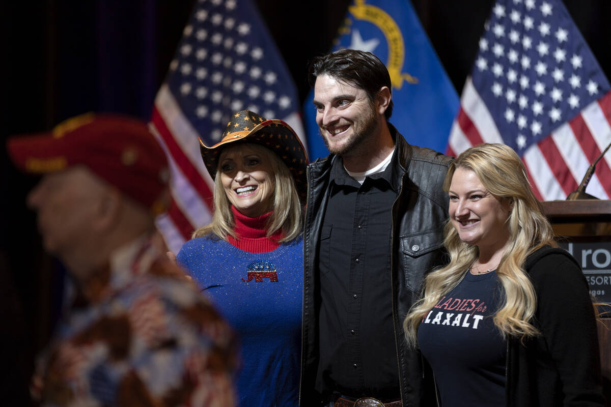 Attendees pose for photos as they await election results during a GOP watch party at Red Rock C ...