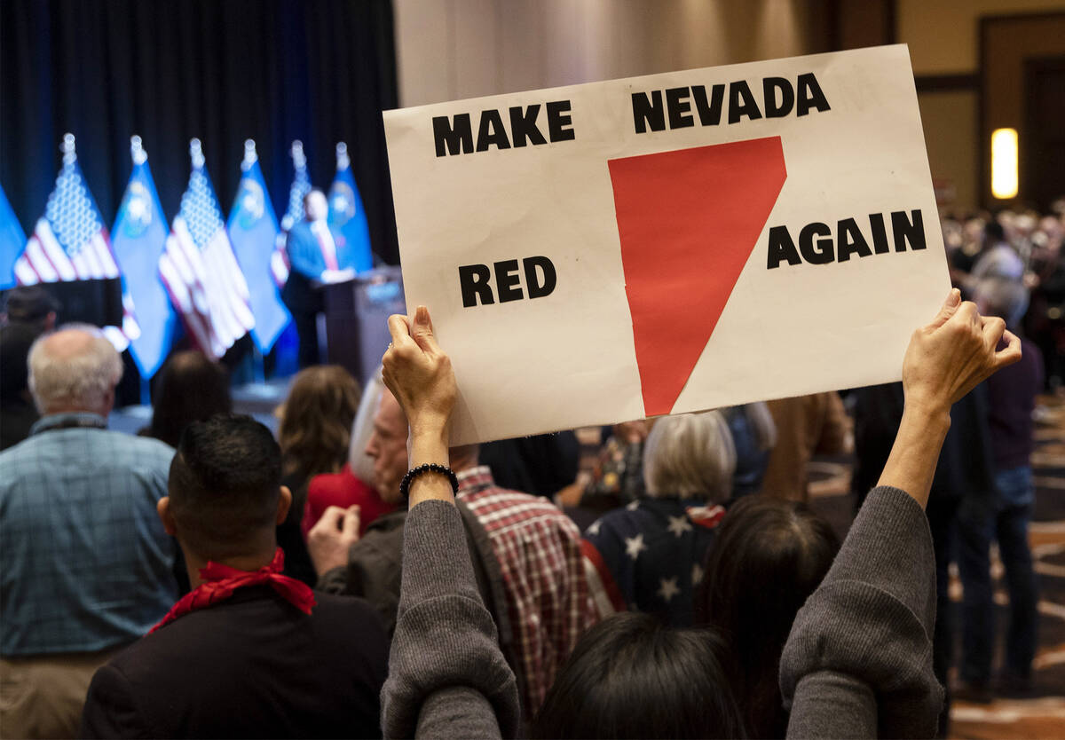 An attendee holds up a sign reading, “make Nevada red again,” during a GOP midter ...