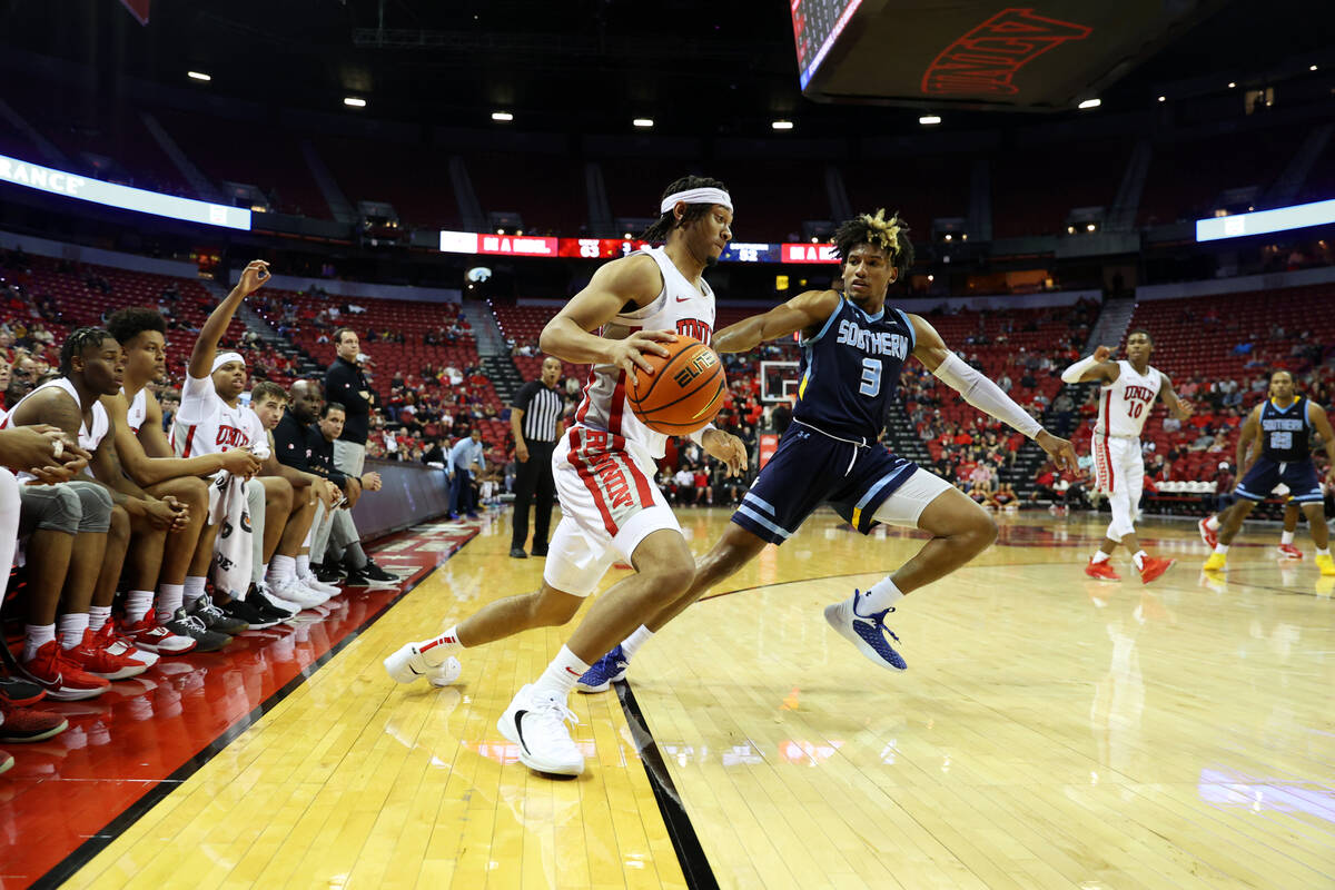 UNLV Rebels guard Justin Webster (2) looks for an open lane under pressure from Southern Univer ...