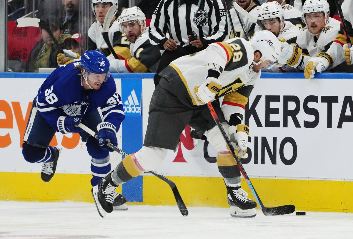 Vegas Golden Knights forward William Carrier (28) steals the puck from Toronto Maple Leafs defe ...