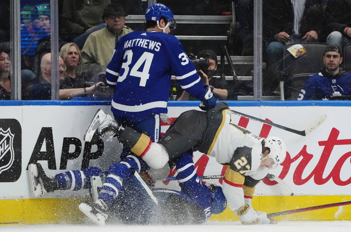 Toronto Maple Leafs forward Auston Matthews (34) hits Vegas Golden Knights defenseman Shea Theo ...