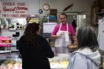 Juan Medina assists customers at his shop, Mrs. Williams’ Diabetic Delights, where the b ...