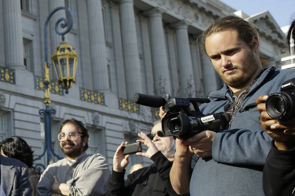 FILE - David DePape, right, records the nude wedding of Gypsy Taub outside City Hall on Dec. 19 ...