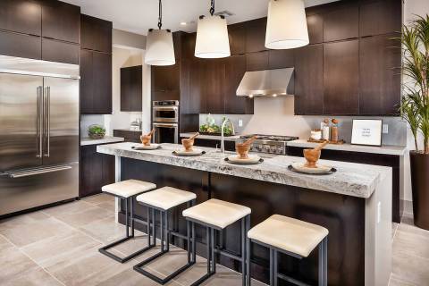 This kitchen in a Toll Brothers home in Acadia Ridge shows the comeback trend for darker wood s ...