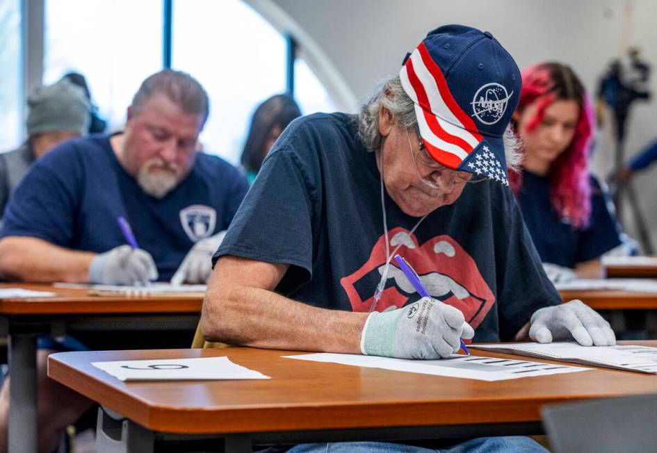 Volunteers resume hand counting ballots in Nye County at the Valley Conference Center on Thursd ...