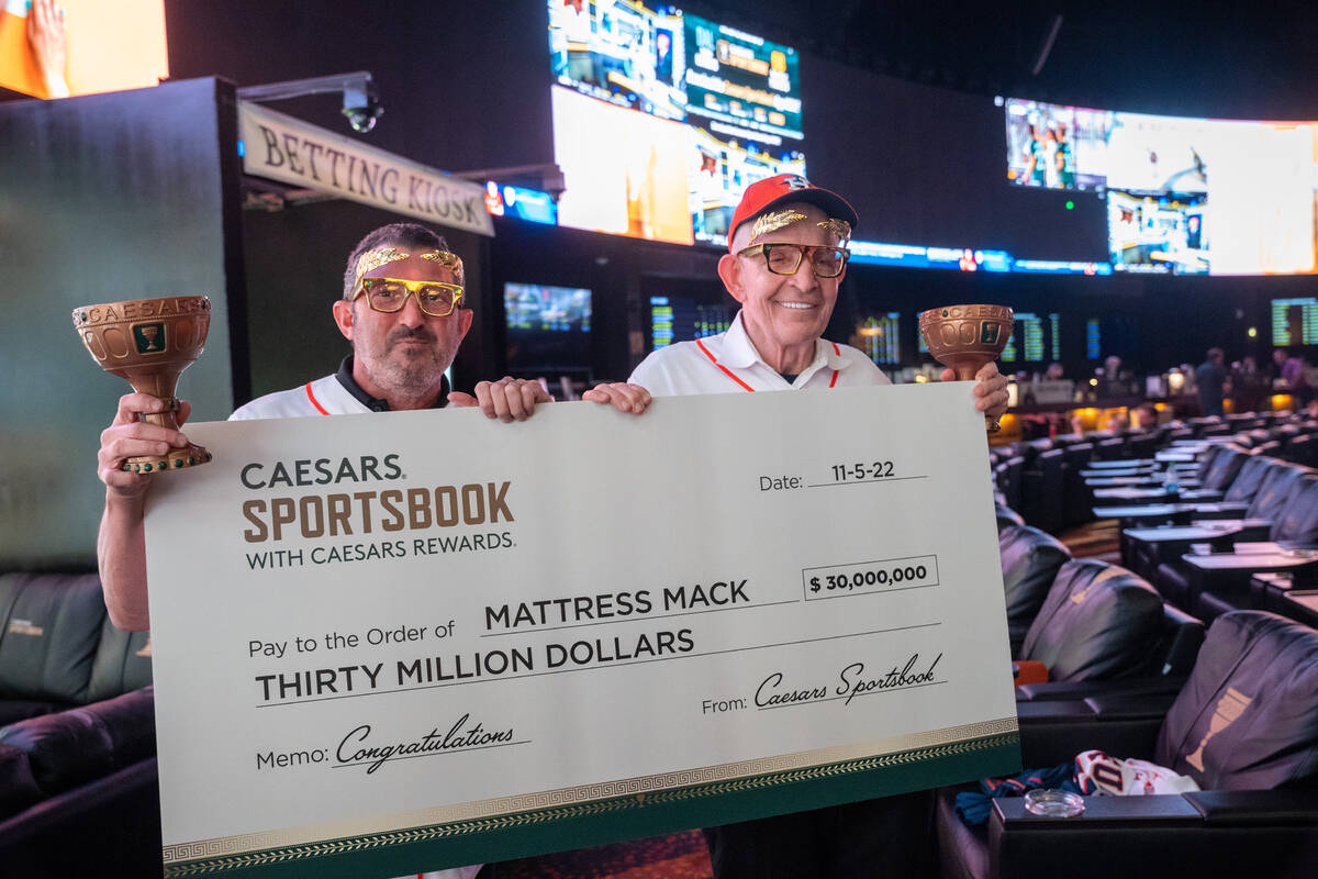 Jim “Mattress Mack” McIngvale, right, shows off his $30 million World Series win Thursday, ...