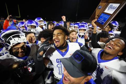 Bishop Gorman players including Palaie Faoa (10), center, celebrate a win in the football 5A re ...