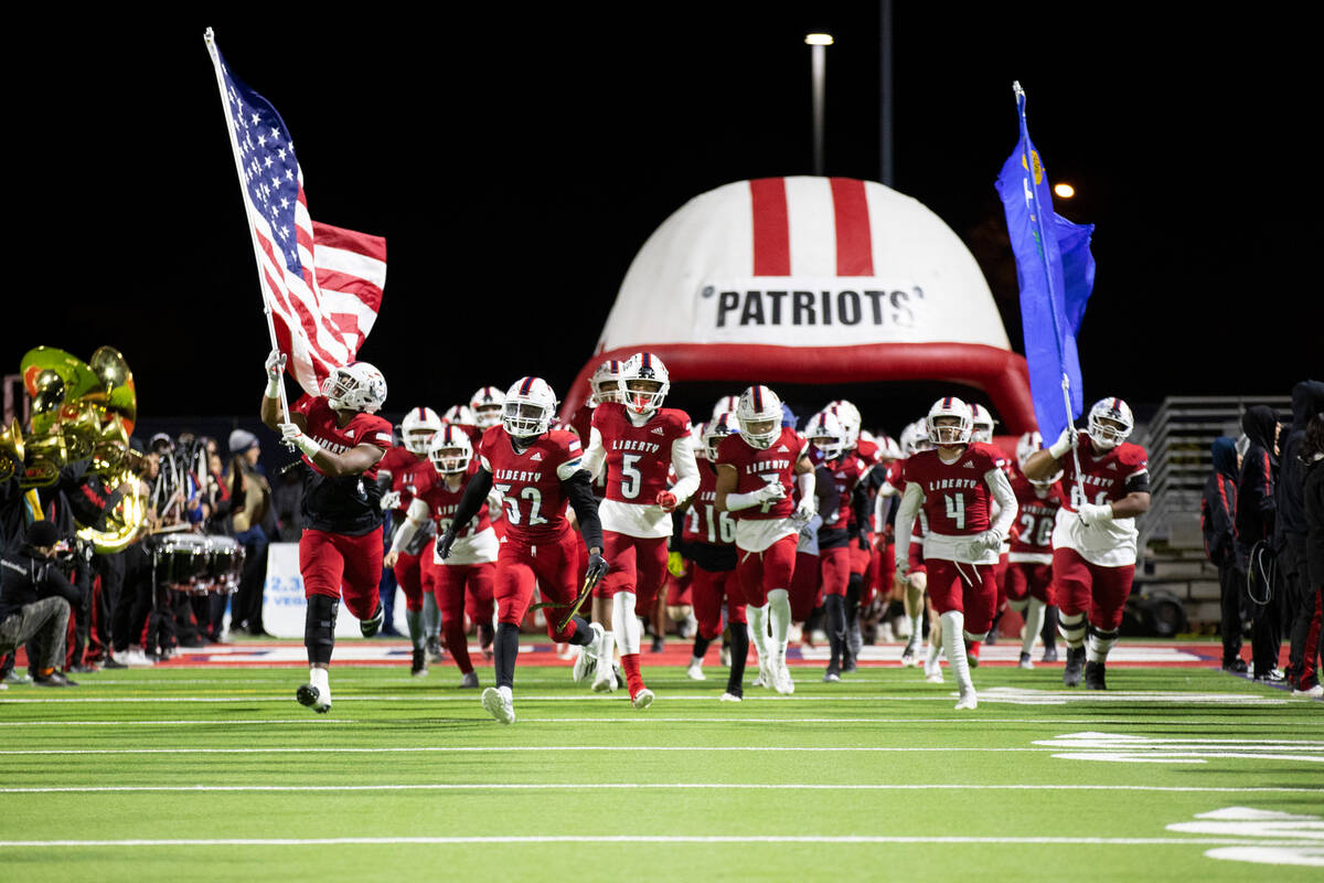 Liberty takes the field before the start of the football 5A regional final against Bishop Gorma ...