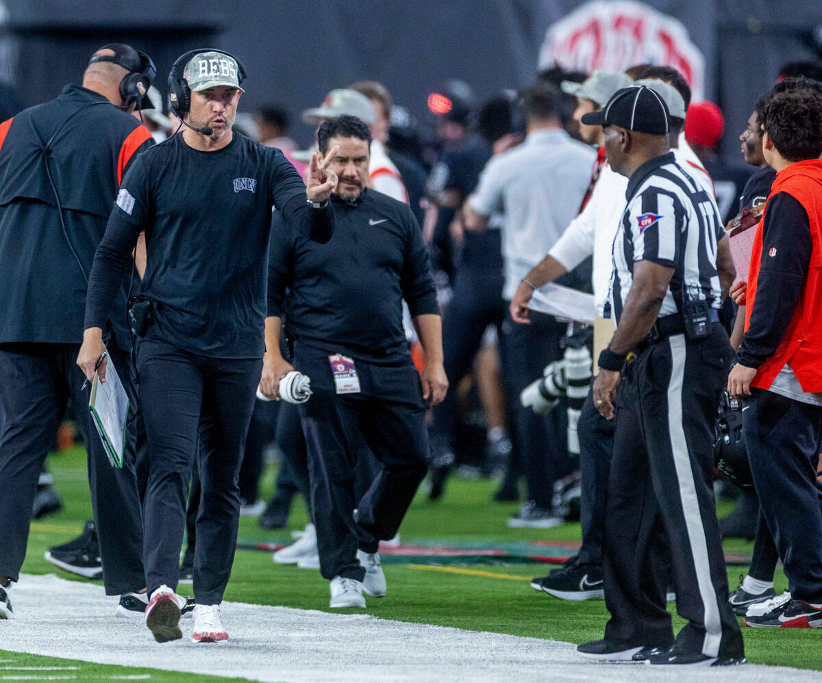 UNLV Head Coach Marcus Arroyo signals he will go for two points after a touchdown versus the Fr ...