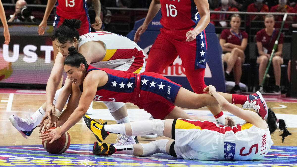 United States' Kelsey Plum dives for the ball with China's Li Yueru, top, and Wang Siyu (5) dur ...