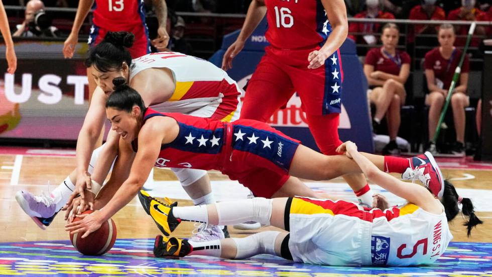 United States' Kelsey Plum dives for the ball with China's Li Yueru, top, and Wang Siyu (5) dur ...