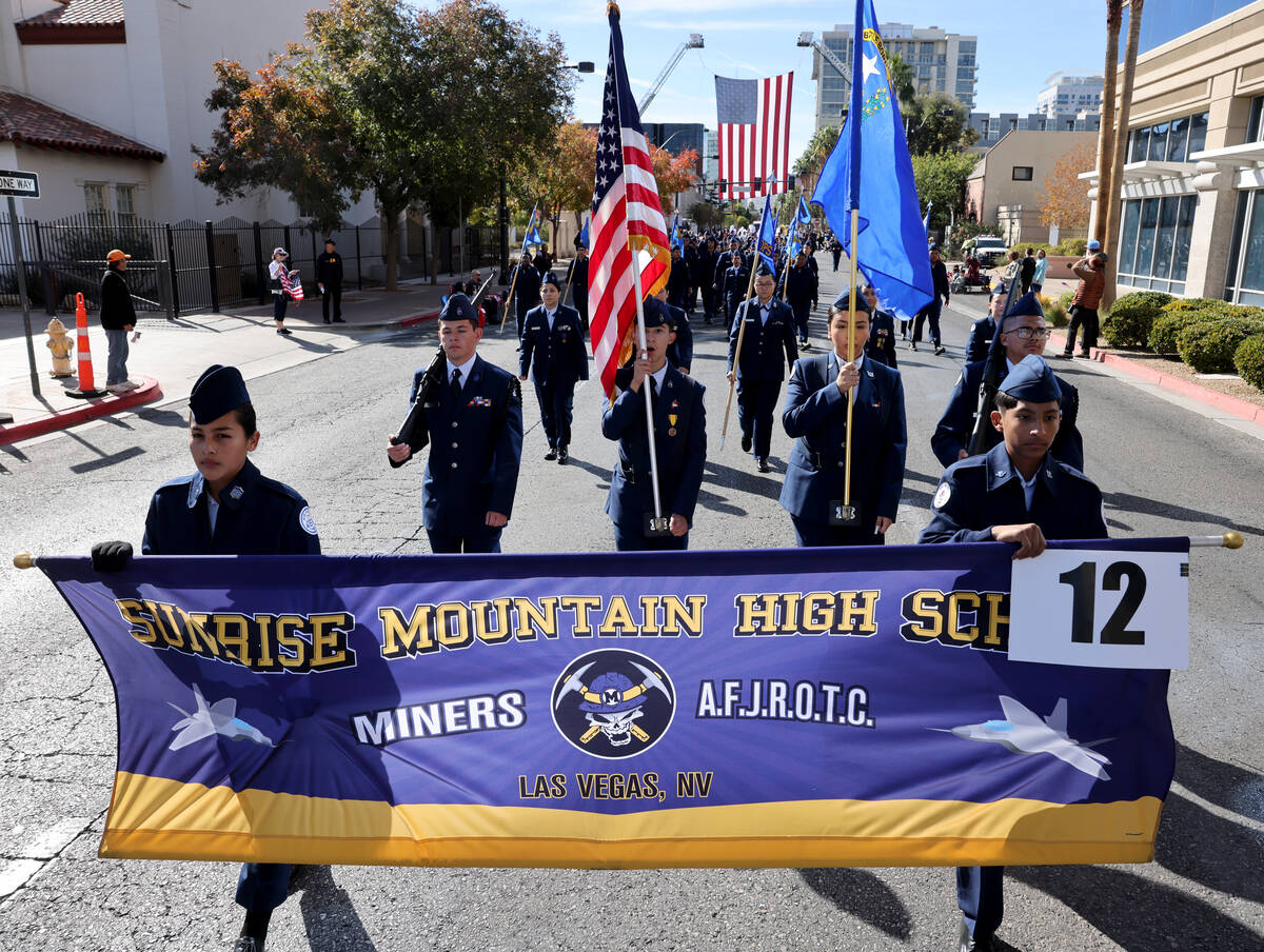 Members of the Sunrise Mountain High School Air Force Junior ROTC march in the Veterans Day par ...